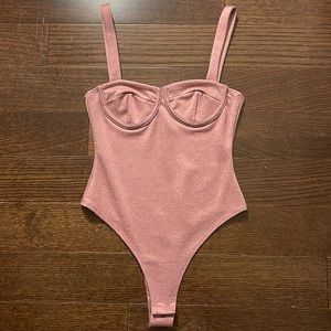 Selling a brand new pink sparkly Forever 21 body suit size S.